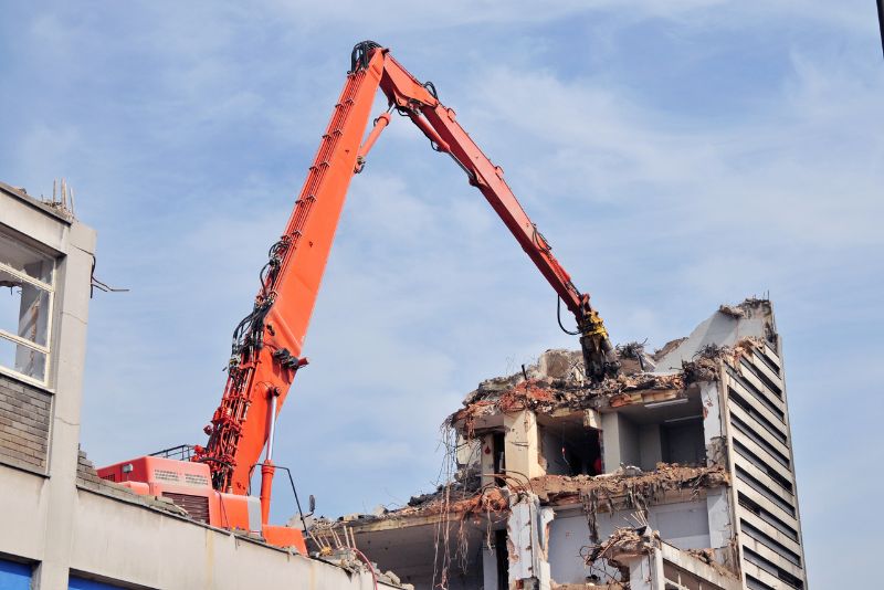 office blocks demolished by an excavator
