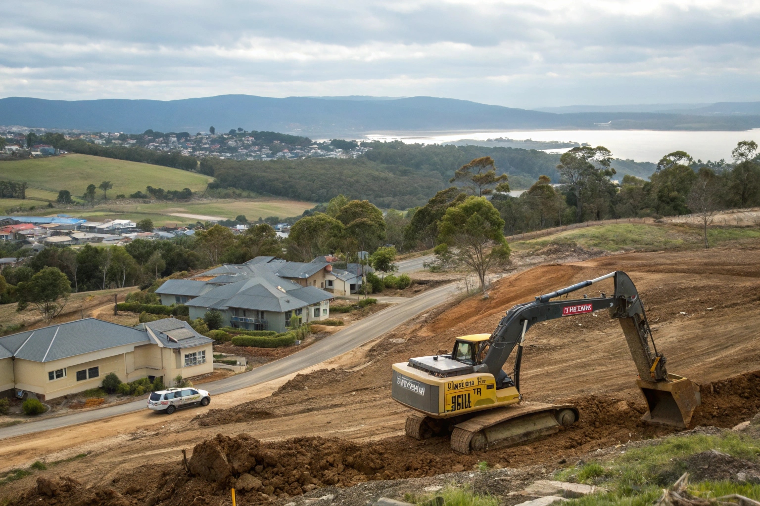 Excavator preparing large block subdivision site in Tranmere with Eastern Shore views